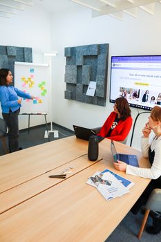 Women collaborating on business strategies during a modern office meeting.