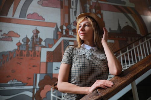 Woman Posing with Mural on Wall behind