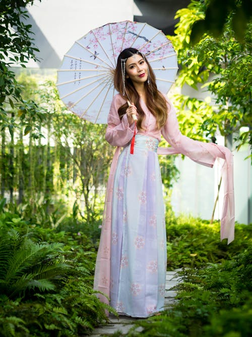 Woman Posing in Traditional Dress and with Umbrella