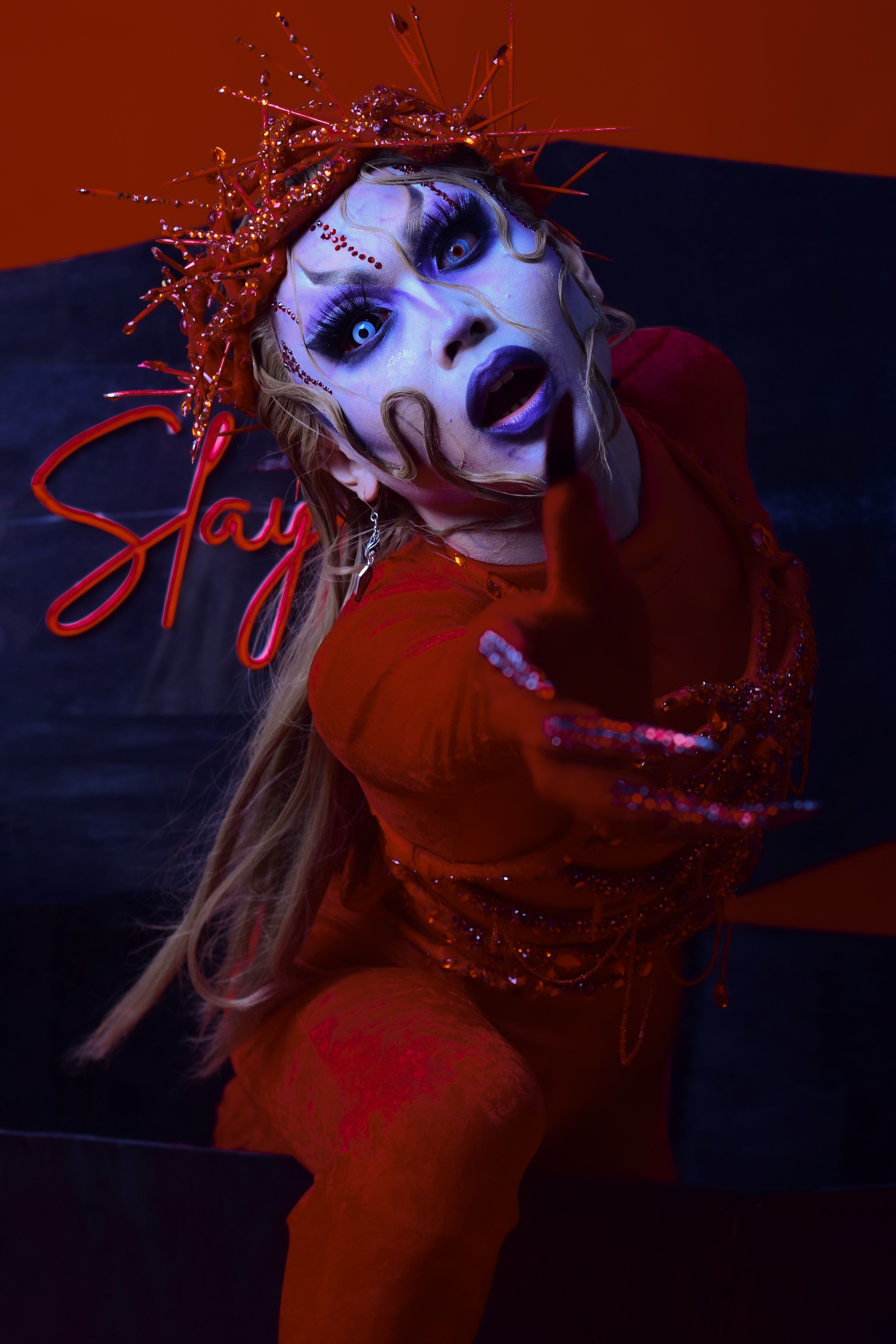 Intense makeup and costume in a captivating performance art setting.