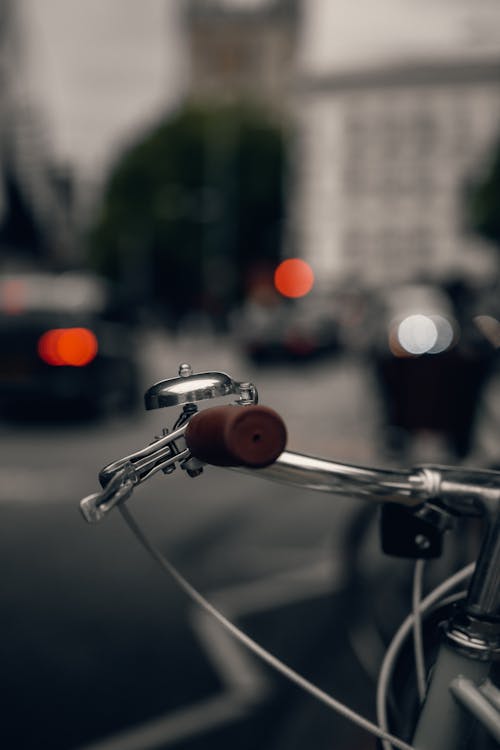 A close up of a bike handlebar with a red light