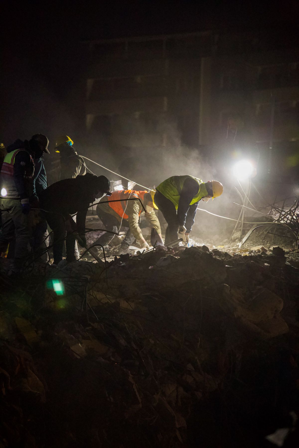 Site crew working an excavation area at night under bright work lighting