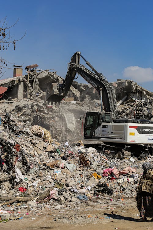 A dump truck picking up debris remains