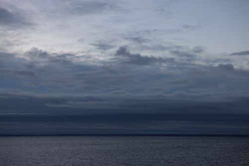 Free Moody overcast sky over the ocean at Stamford, CT, creating a serene seascape. Stock Photo