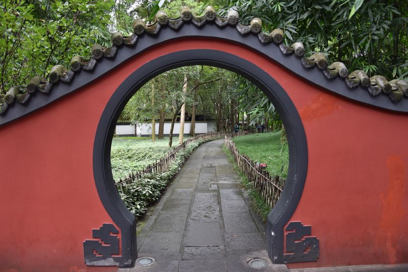 Round moon gate in a red wall at Du Fu Thatched Cottage garden