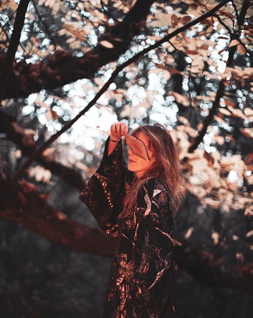 Fashion Model Posing by Tree with Dried Leaf