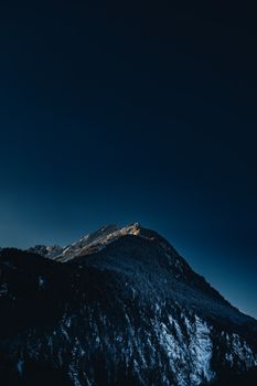 Breathtaking view of snow-covered mountains in Mayrhofen, Tyrol, at twilight.