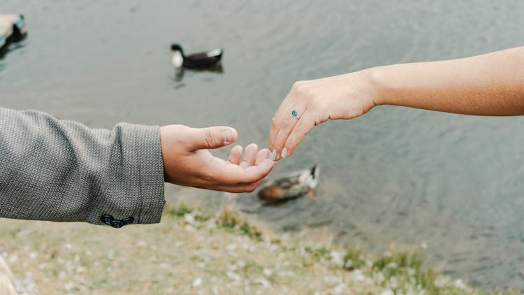 Couple Holding Hands, Showing Engagement Ring