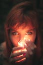 Close-up Photography of Woman Holding String Lights