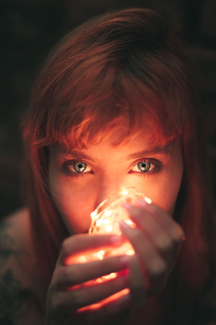 Close-up Photography Of Woman Holding String Lights