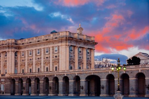 Free Stunning view of the Royal Palace of Madrid with a vibrant sunset sky. Stock Photo