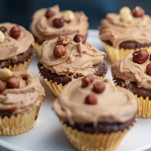 Free Close-up of Cupcakes with Nuts and Chocolate Icing Stock Photo
