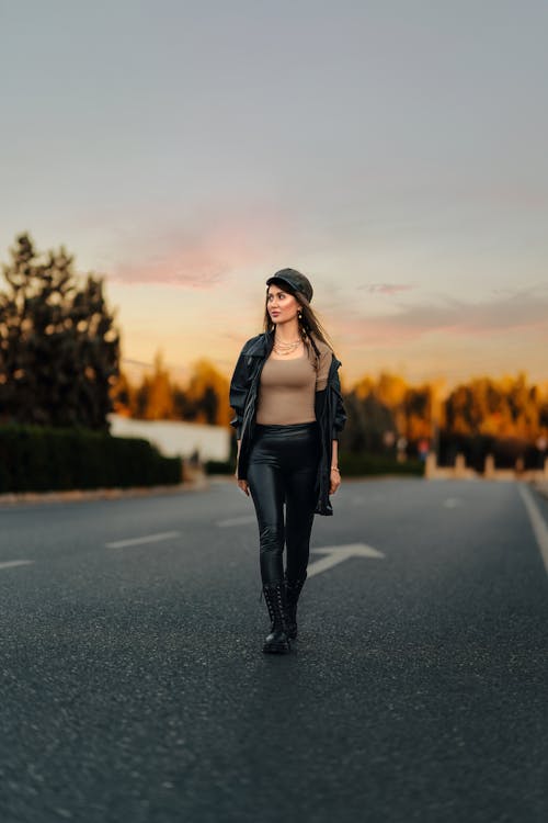 Foto de pretty girl in black sweater and leather pants do Stock