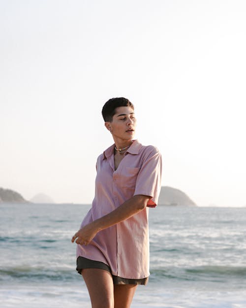 Woman in Pink Shirt at the Seaside 