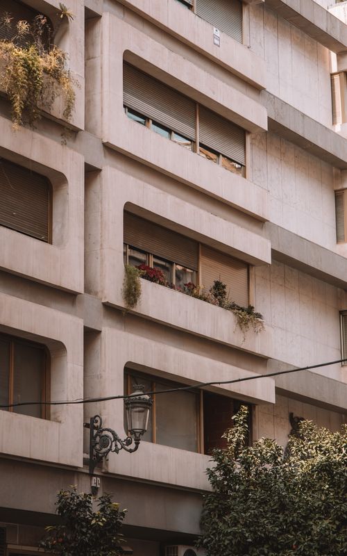 Free Detailed modern residential building facade in Valencia, Spain with urban greenery. Stock Photo