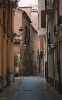Explore the vintage architecture along a narrow, charming street in Valencia, Spain's old town.