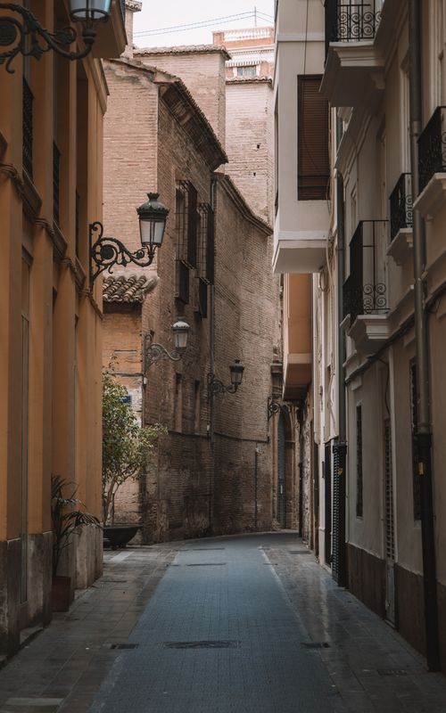 Free Explore the vintage architecture along a narrow, charming street in Valencia, Spain's old town. Stock Photo