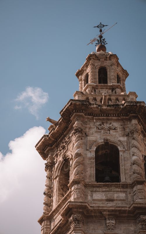 Free Low angle view of a Gothic stone tower against a clear sky in Valencia, Spain. Stock Photo