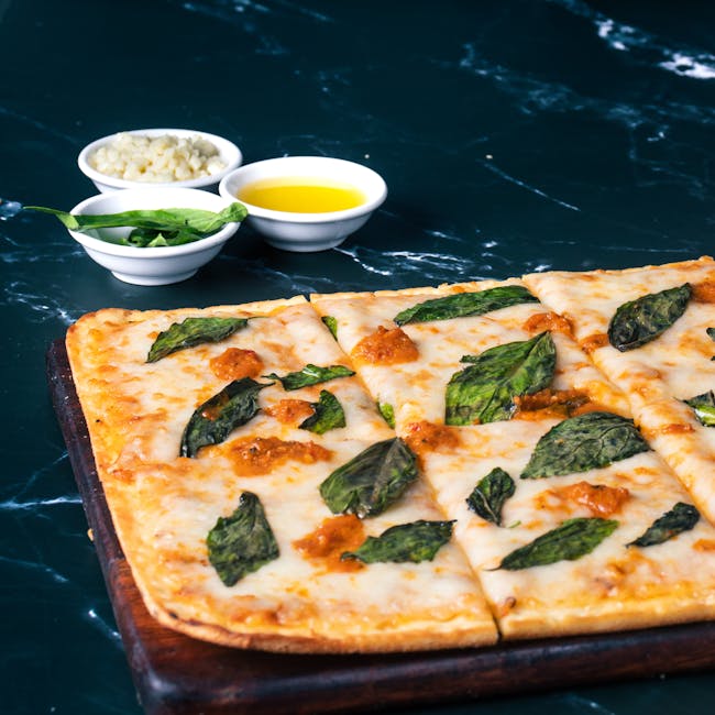Savor a close-up of a mouthwatering basil and cheese pizza with a dark marble background.