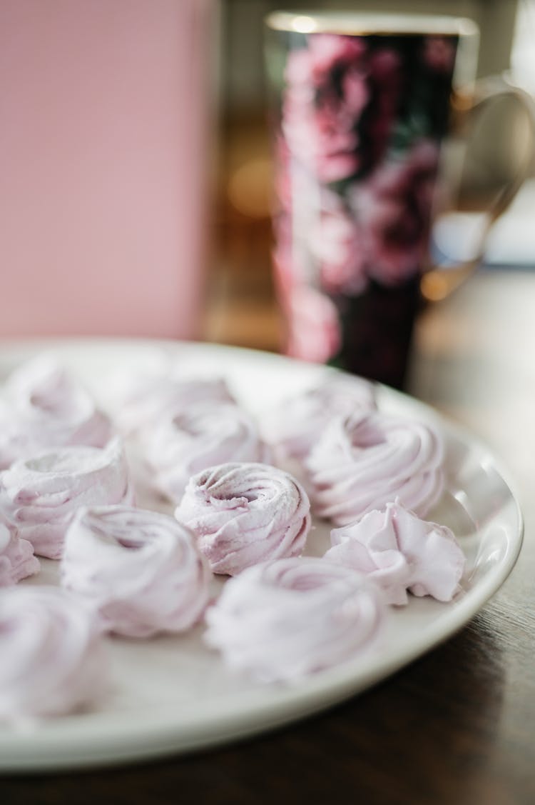 Pink Meringue Cookies On A White Plate