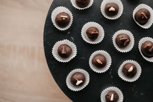 Top View of a Black Plate with Chocolate Pralines