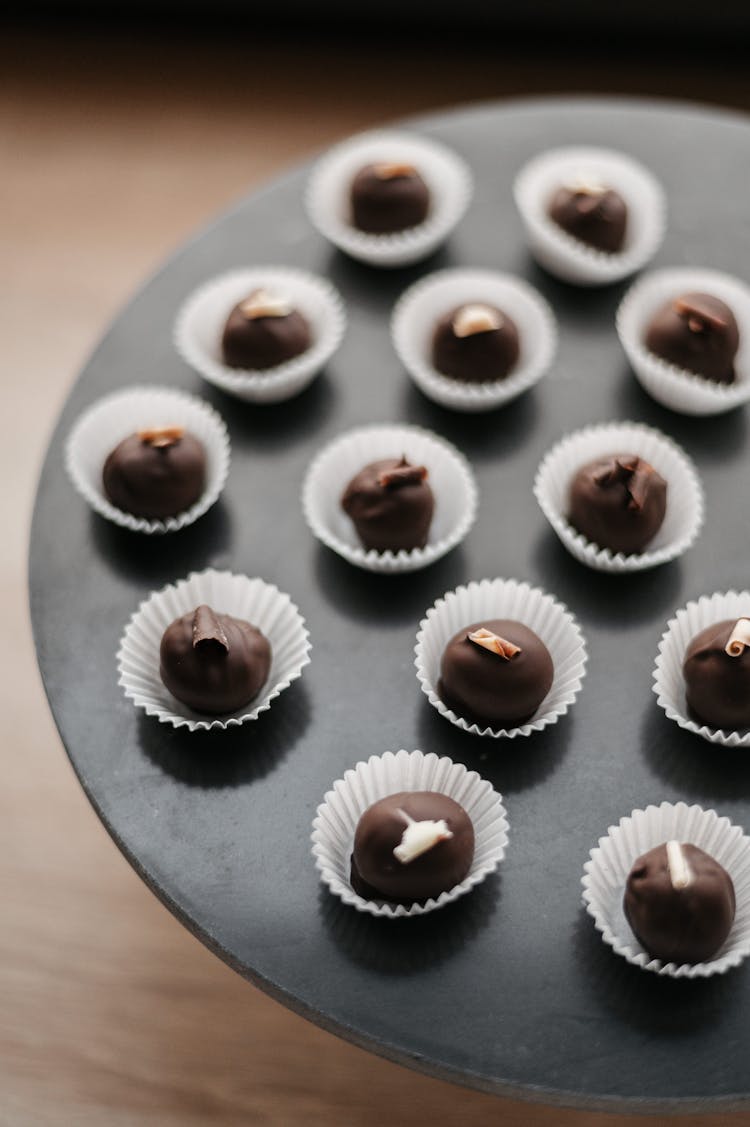 Chocolate Pralines On A Black Plate