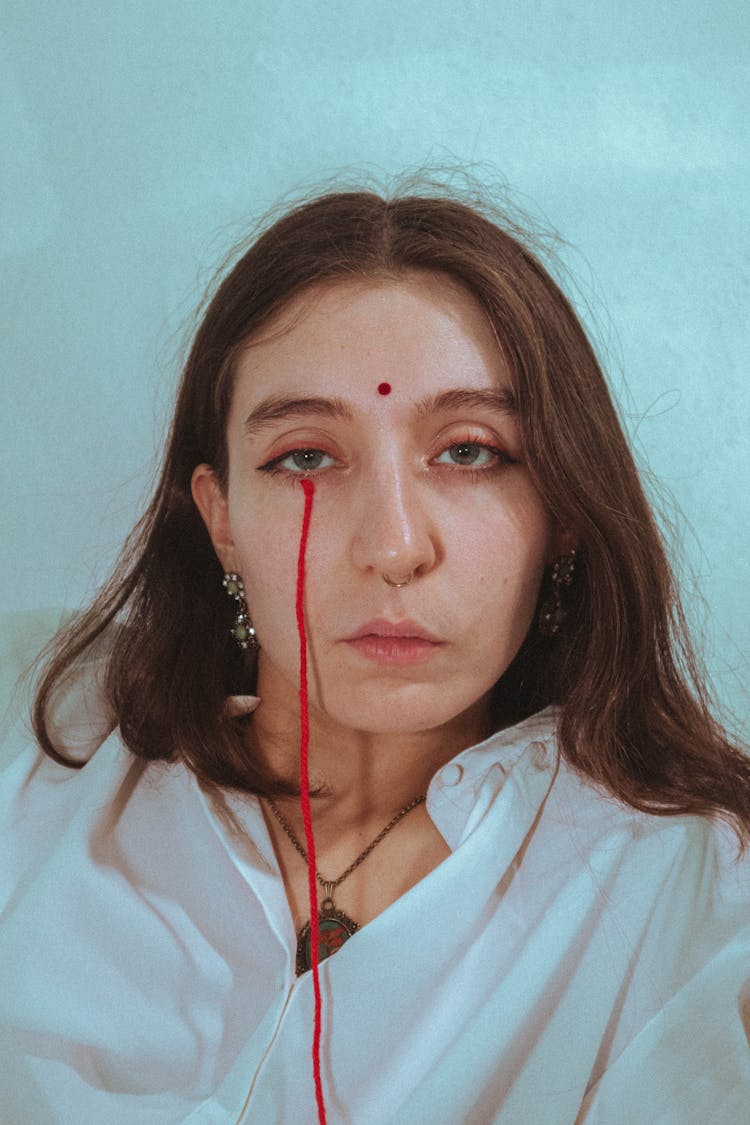 Woman With A Red String Under Her Eye 