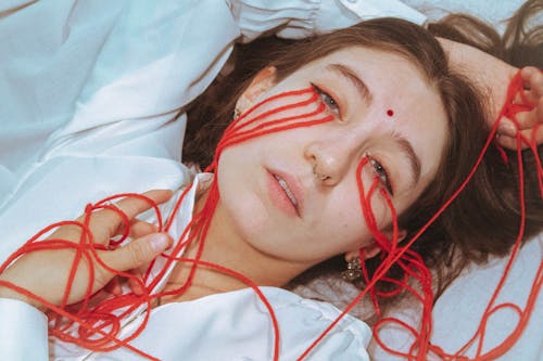 Woman Lying Down with Red String