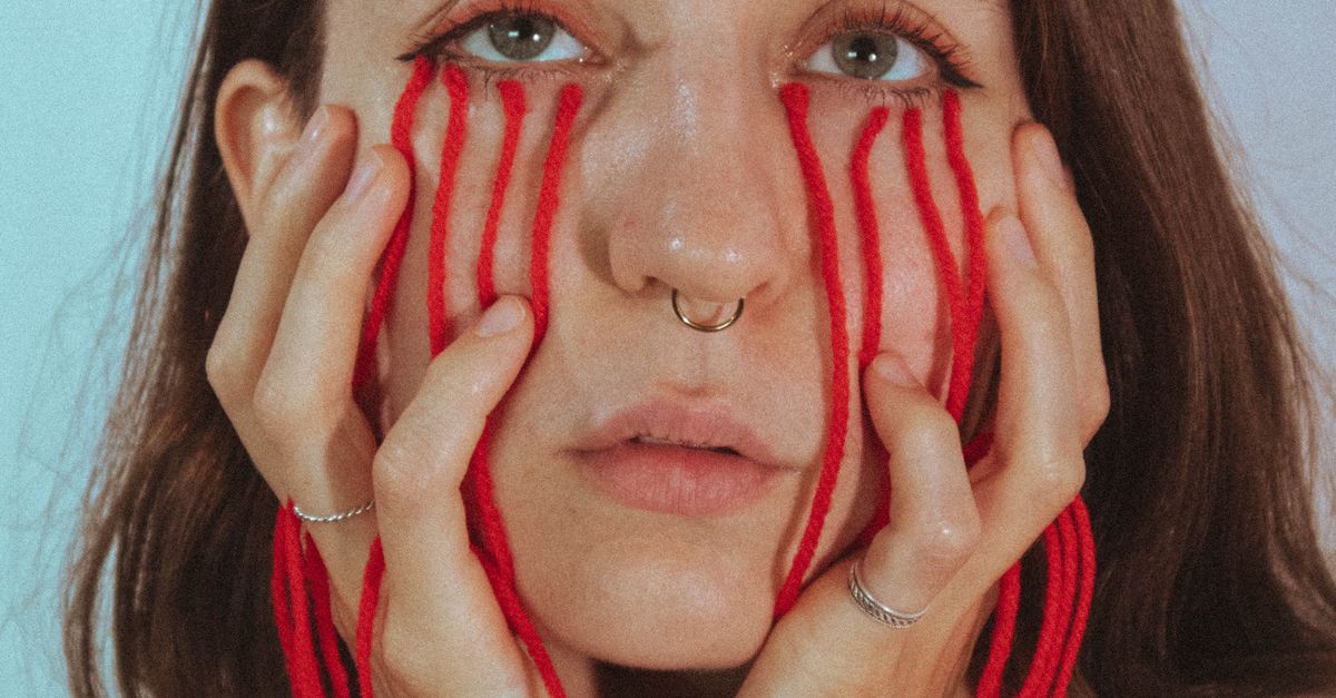Conceptual Photograph of a Woman with Red Strings Attached to Her Face ...