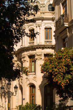 Stunning colonial architecture featuring balconies and ornate windows against a vibrant garden setting.