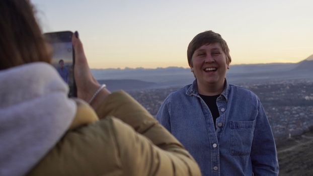 Photo of a Woman Taking a Picture of a Smiling Person