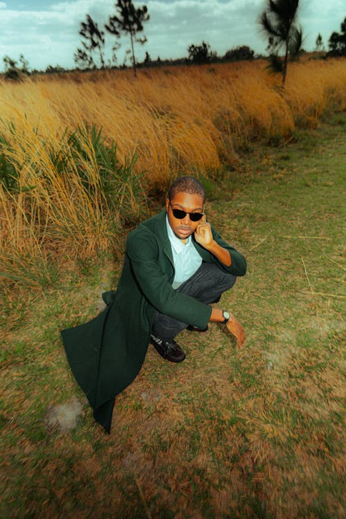 Man Posing in Suit and Sunglasses among Grasses