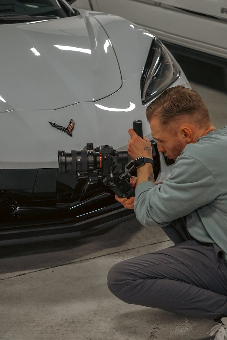 Man Filming Cars With A Professional Camera 