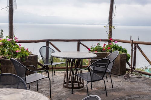 Table and Chairs on Terrace with Sea behind