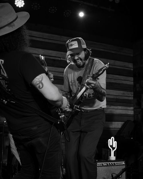 Free Energetic black and white shot of musicians rocking the stage in Orlando. Stock Photo