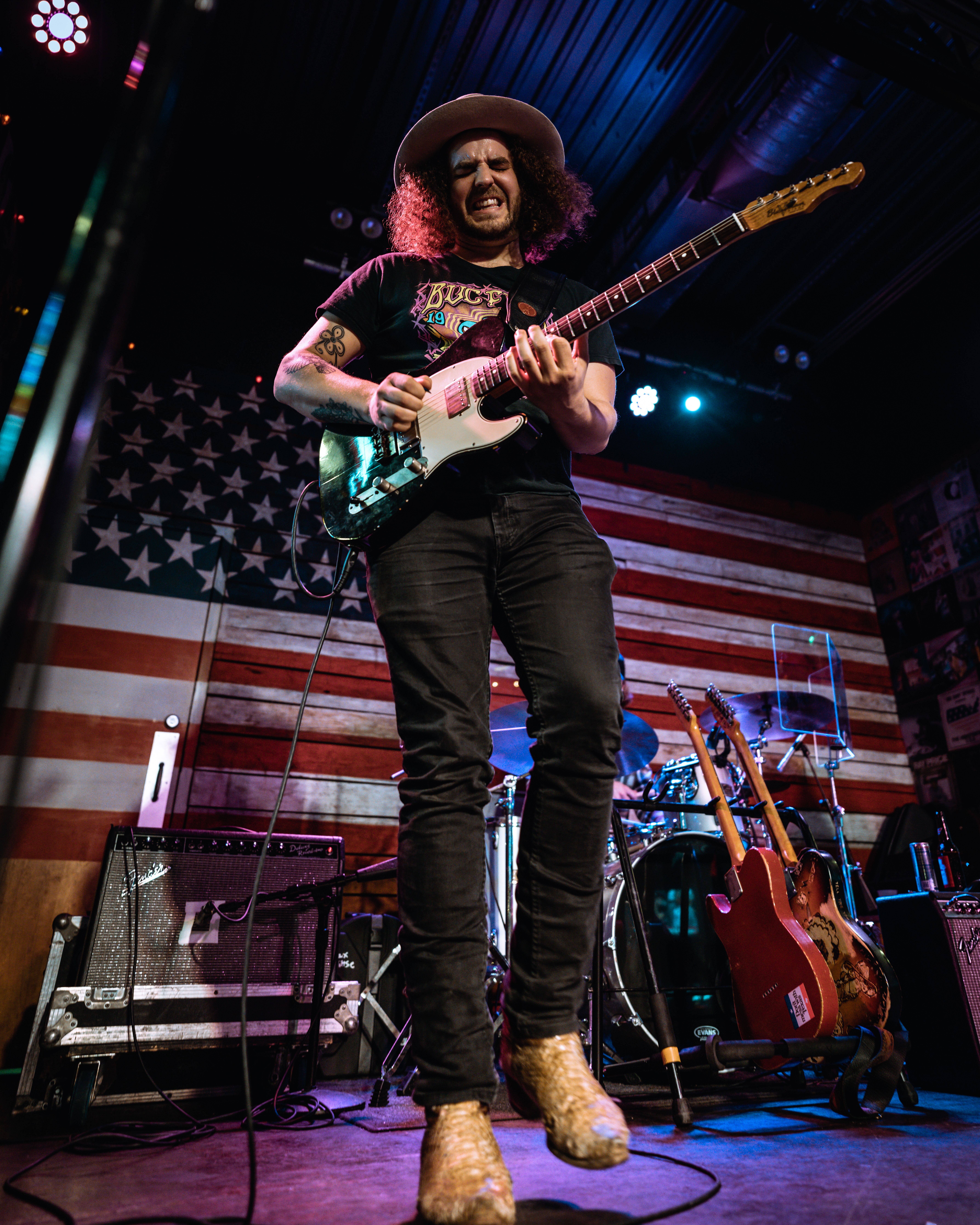 Dynamic guitarist playing live on stage in Orlando, showcasing vibrant musical energy and skill.