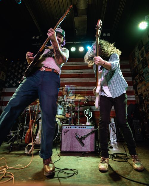 Free Musicians rocking the stage with electric guitars and drum kit during a live performance in Orlando. Stock Photo