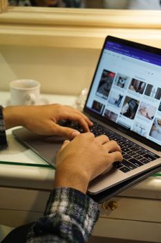 Close-up view of hands typing on a laptop, perfect for technology or work-from-home concepts.