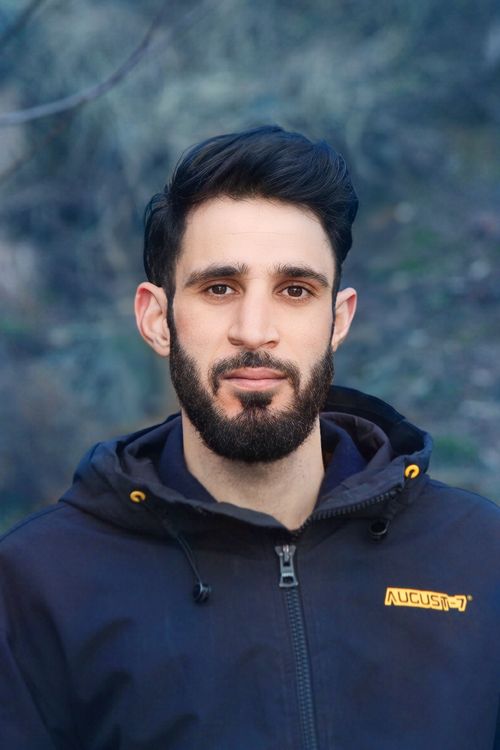 Free Portrait of a man with a beard wearing a jacket, outdoors in Sopore. Stock Photo
