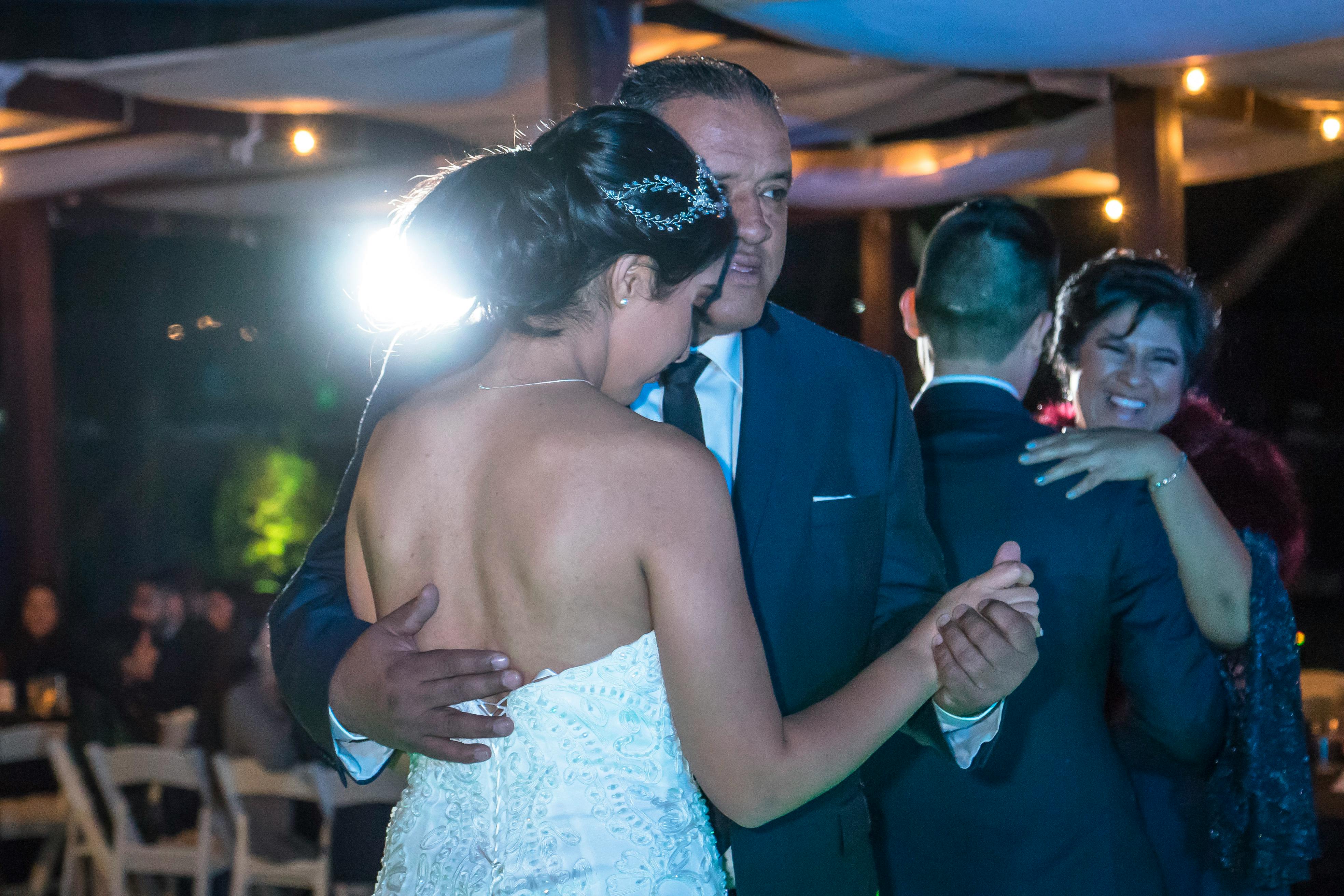 A touching father-daughter dance at an elegant evening wedding reception.