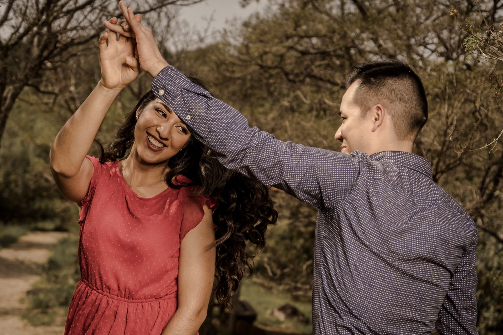 Cha-Cha — smiling couple dancing playfully in a park. Stock photo.