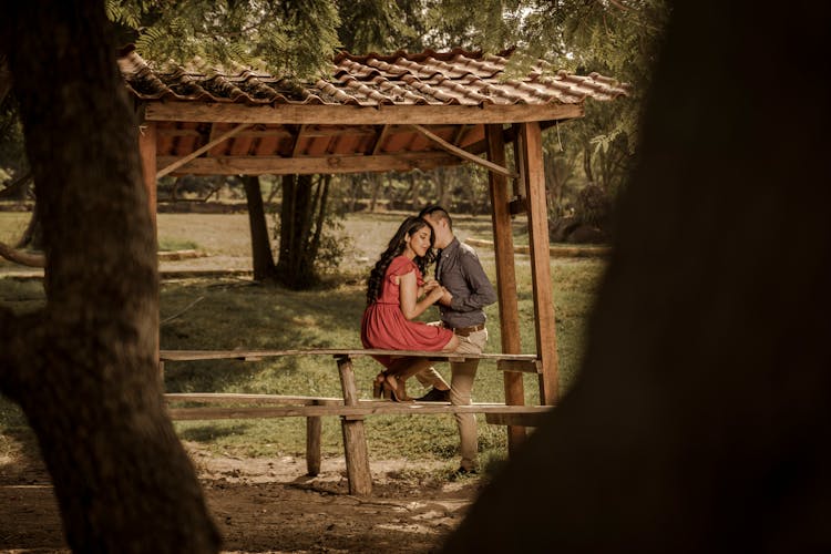 Couple Embracing On Picnic Table