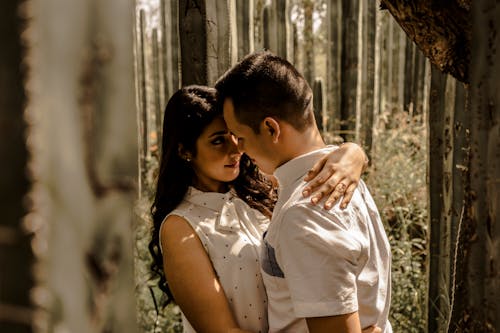 Embracing Couple Standing in the Forest