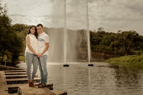 Couple Posing Against Fountains on Lake