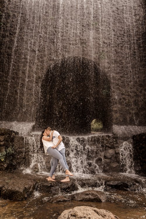 A Couple Kissing under a Waterfall 