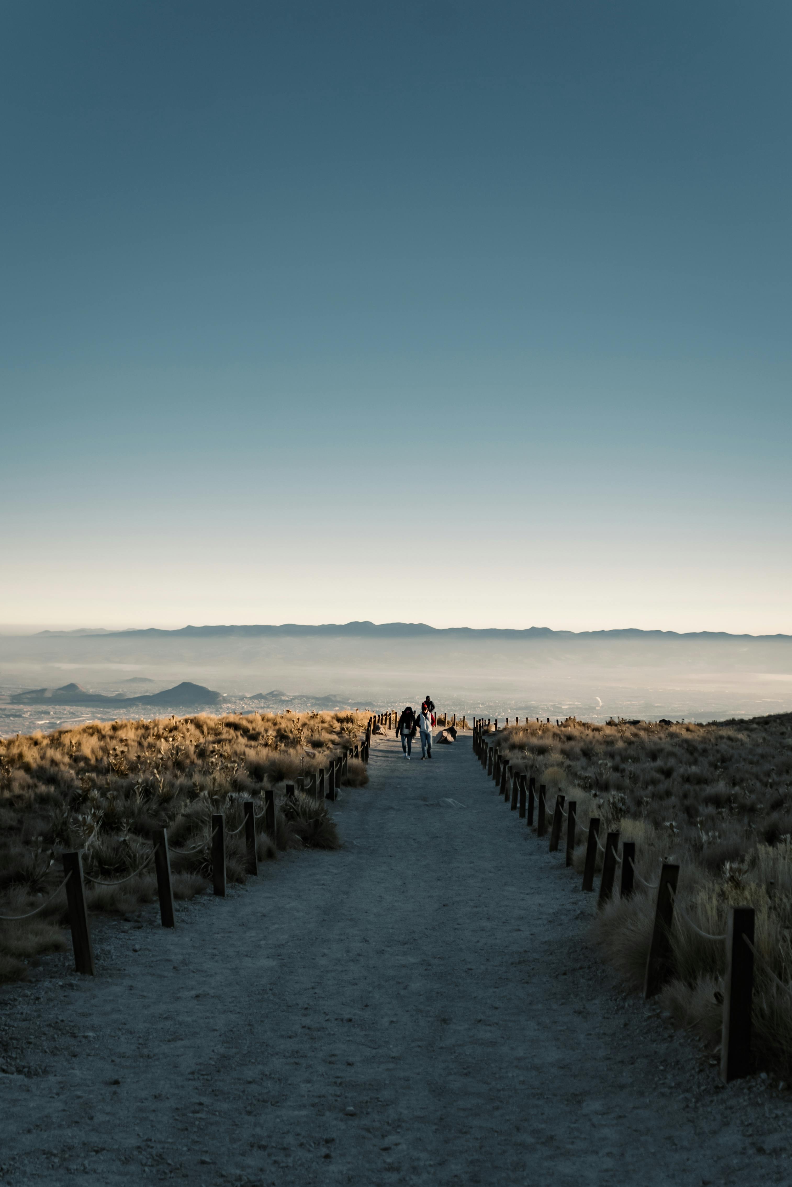 A breathtaking view of hikers on a mountain trail in Toluca, Mexico during sunrise.