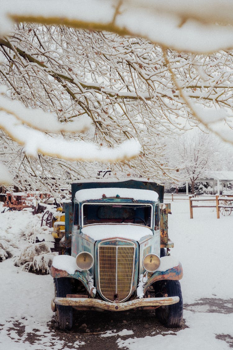 Old Rusty Car Covered In Snow 