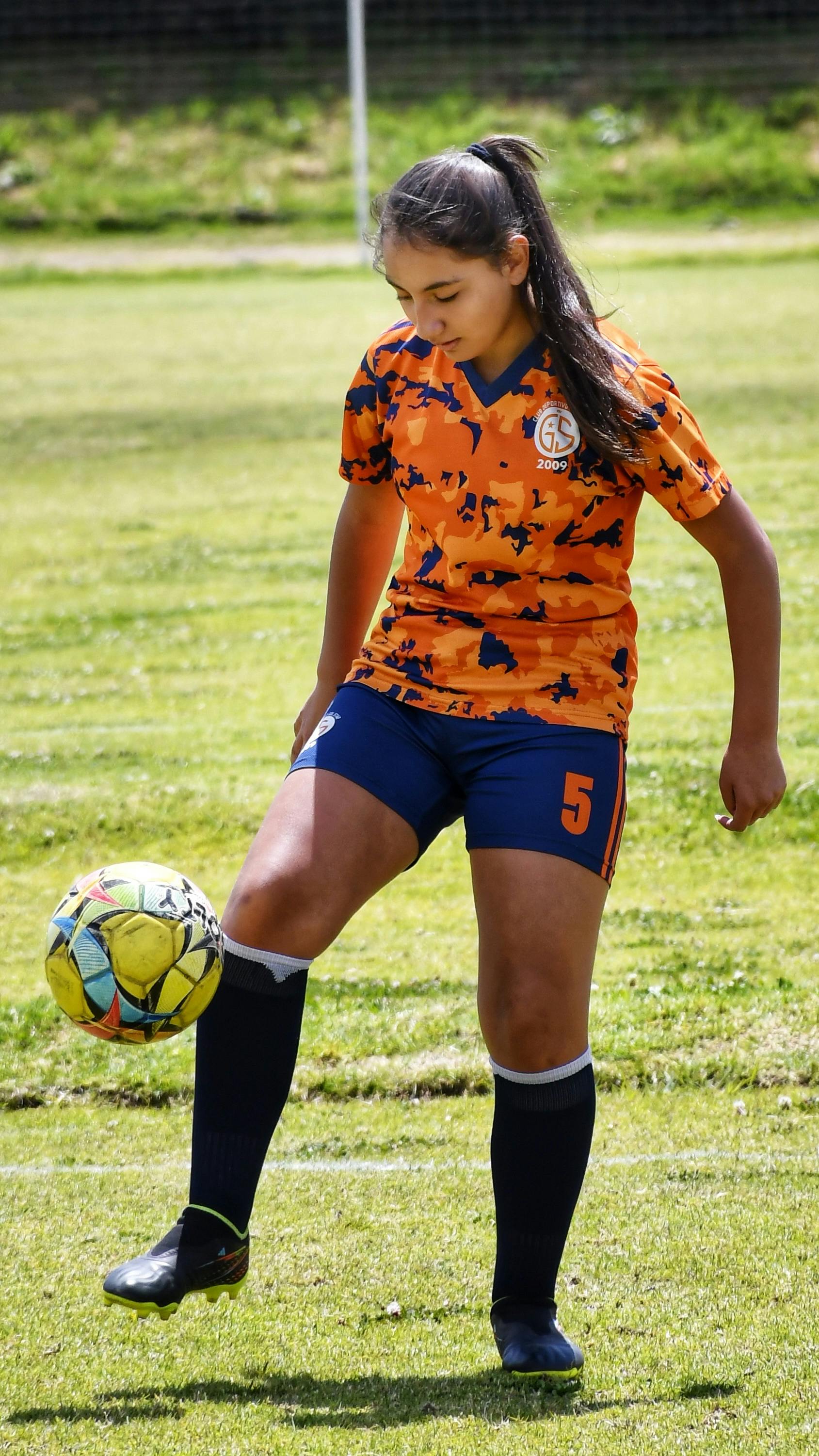 Girl juggling shop soccer ball