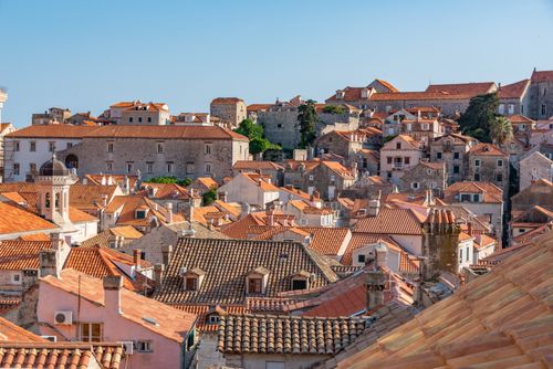 Free A picturesque view of Dubrovnik's historic terracotta rooftops under a clear sky. Stock Photo