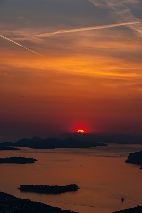 Free A breathtaking aerial view of islands under a vibrant sunset sky. Stock Photo